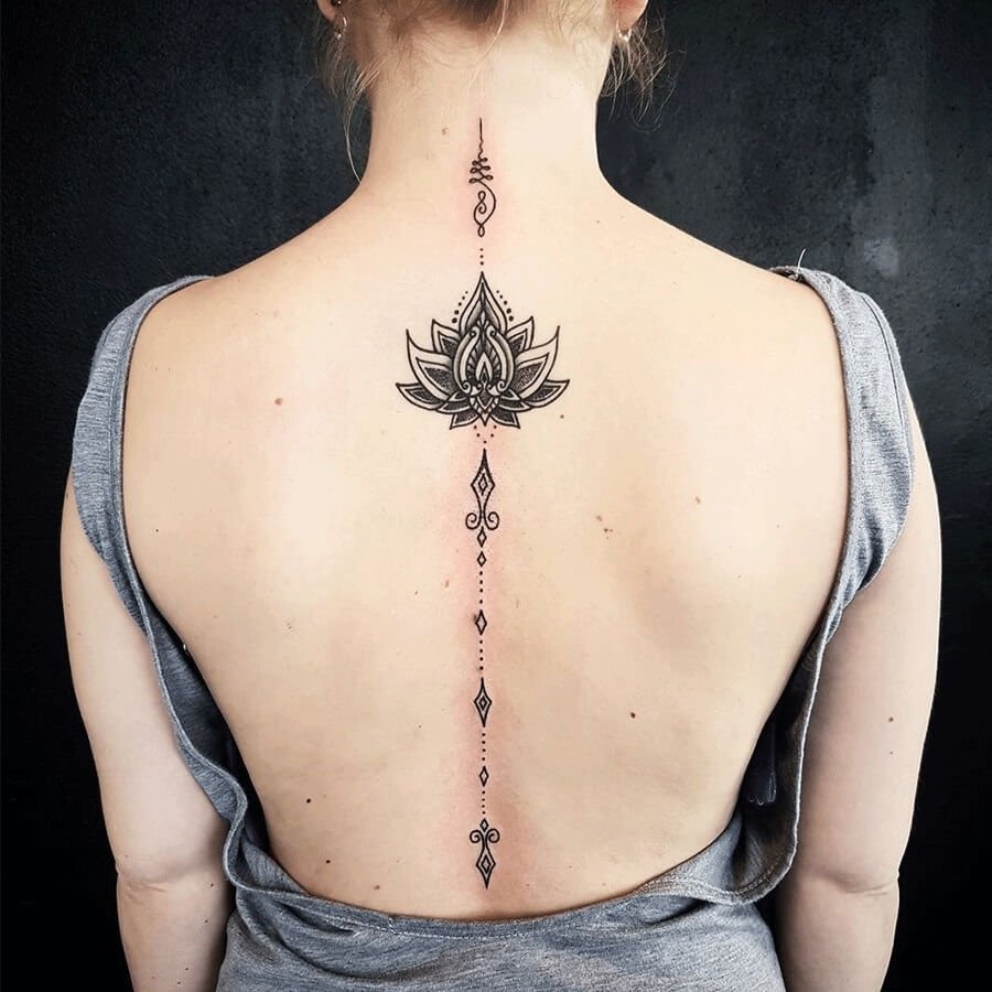 Lotus tattoo on the spine for women