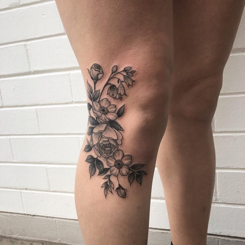 Flower tattoo on the knee for women