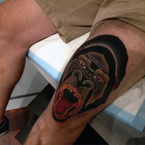 Large gorilla tattoo on the knee for men