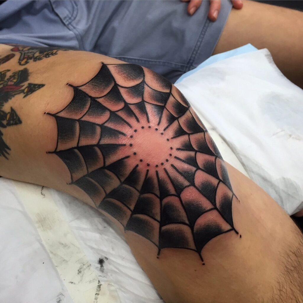 Spider web tattoo on the knee for men