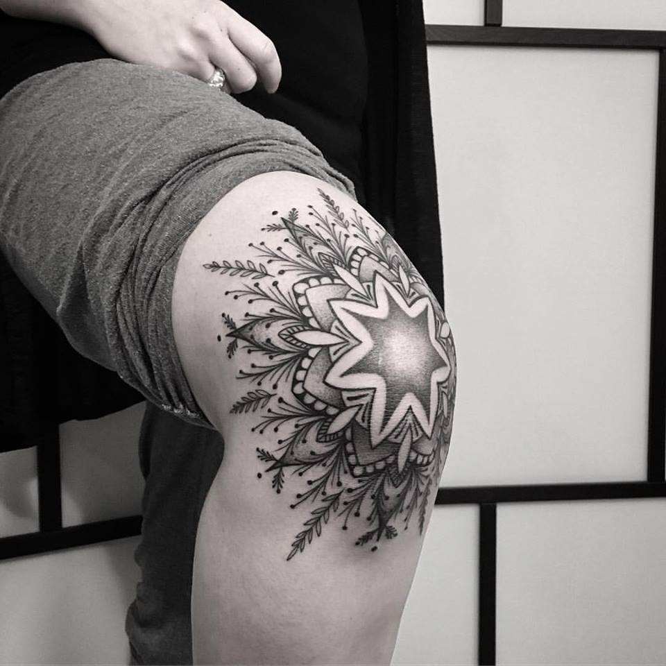 arge flower tattoo on the knee for men