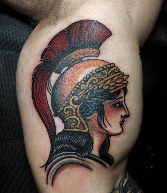 Colored tattoo in the greek style on the biceps for men