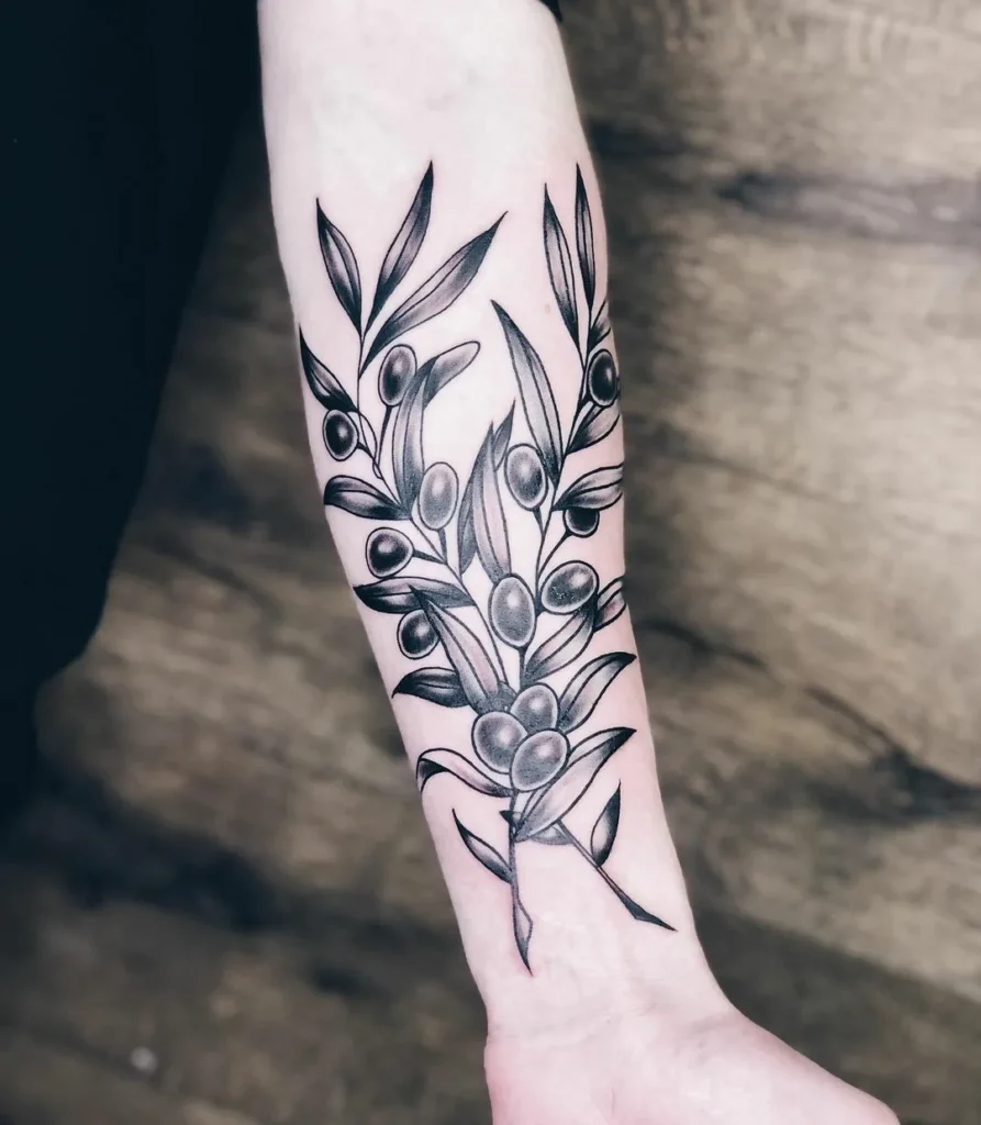 Tattoo of an olive on the forearm for women