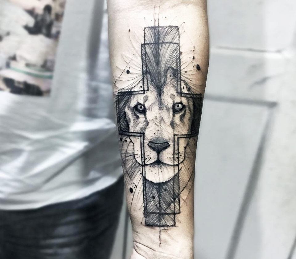 Large lion and cross tattoo on the forearm for men