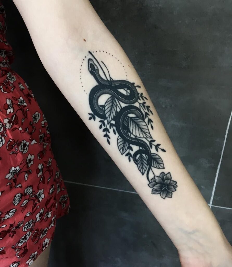 Snake and flowers tattoo on the forearm for women