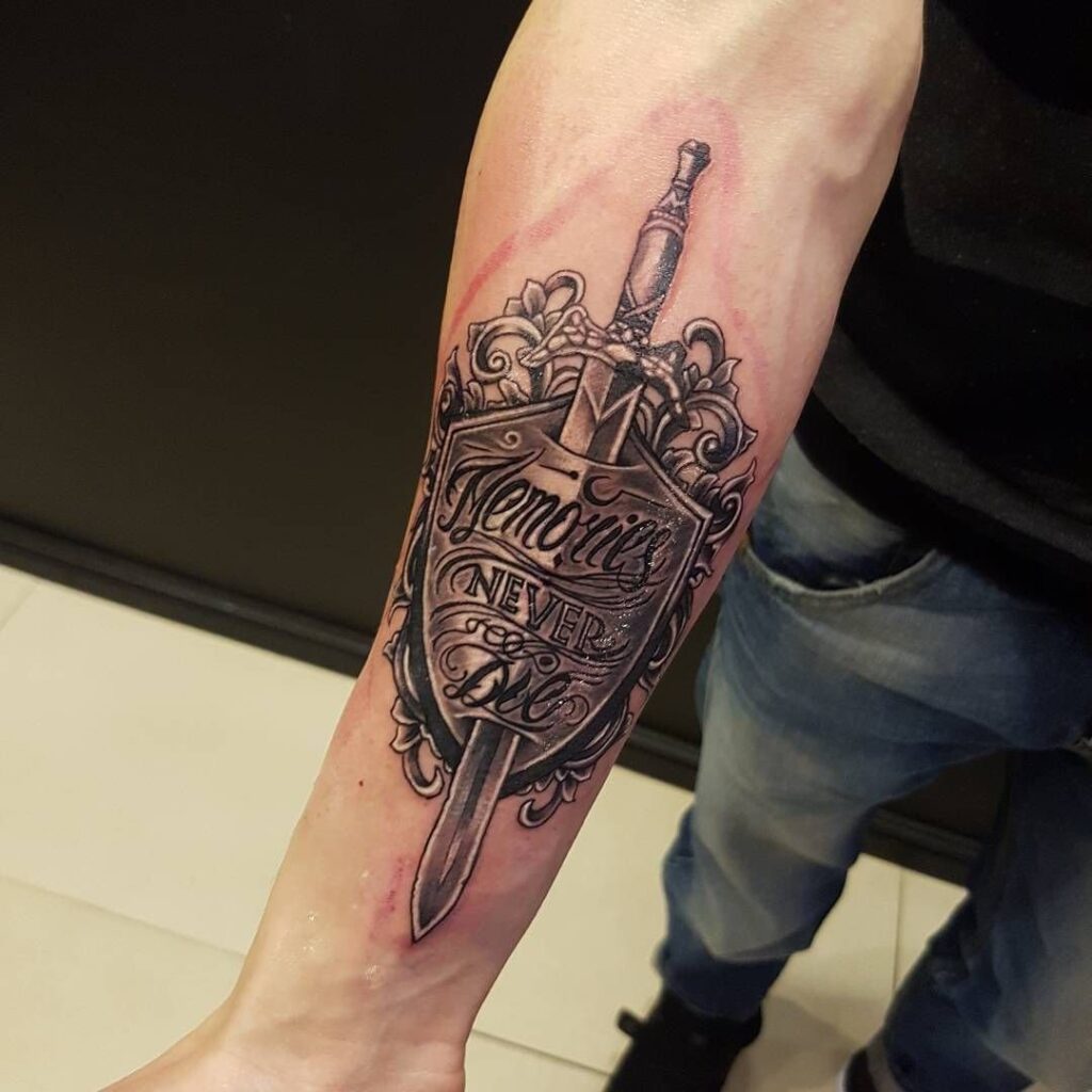 Tattoo of a dagger with an inscription on the forearm for men