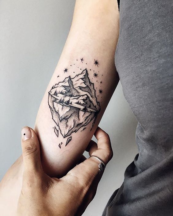 Tattoo of mountains in dotwork style on the shoulder for women