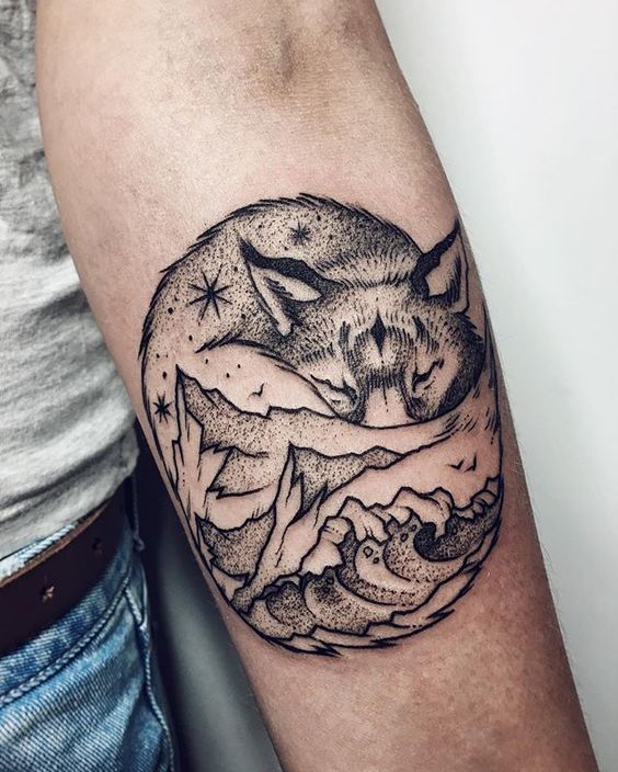 Dotwork fox and mountain tattoo on the forearm for men