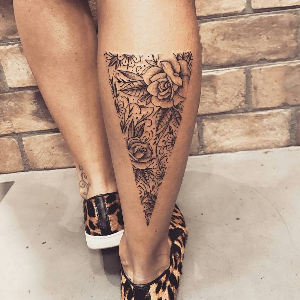 Large rose tattoo on the calf for women