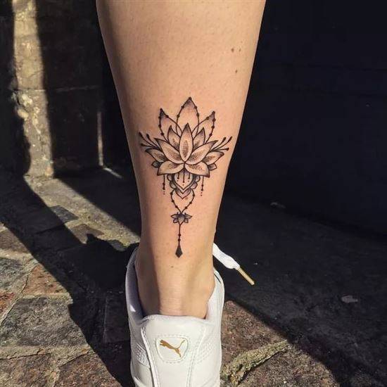 Lotus tattoo on the calf for women