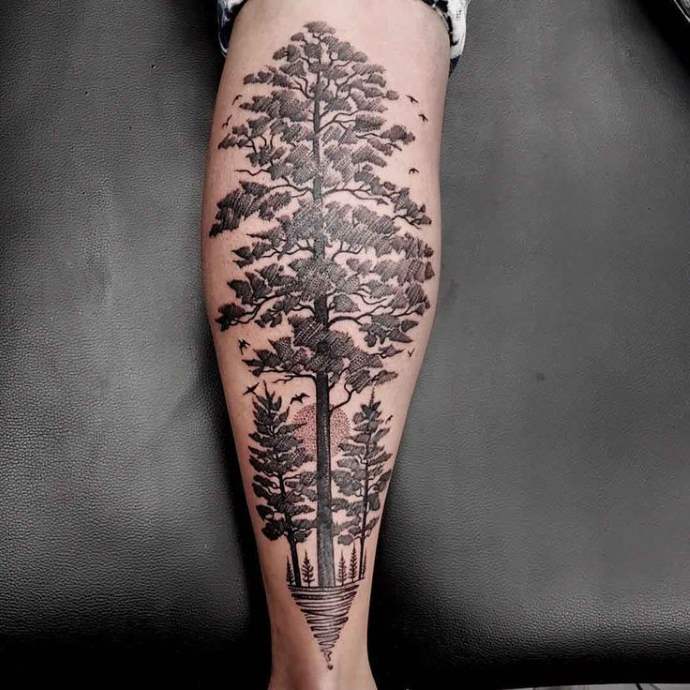 Large tree tattoo on the calf for women