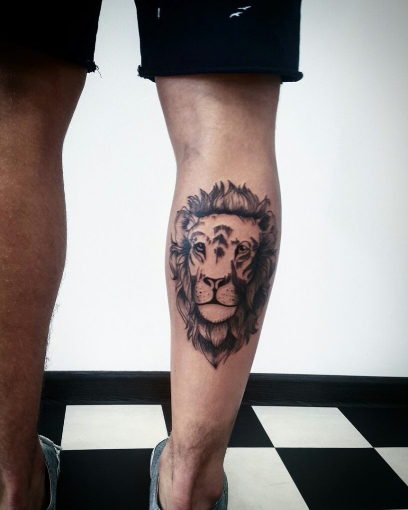 Large lion tattoo on calf for men