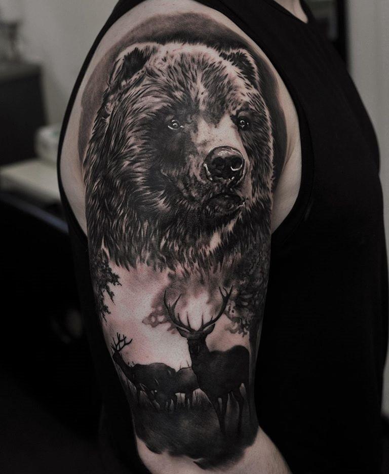 Large tattoo of a bear and deer in Black&Grey style on the shoulder for men