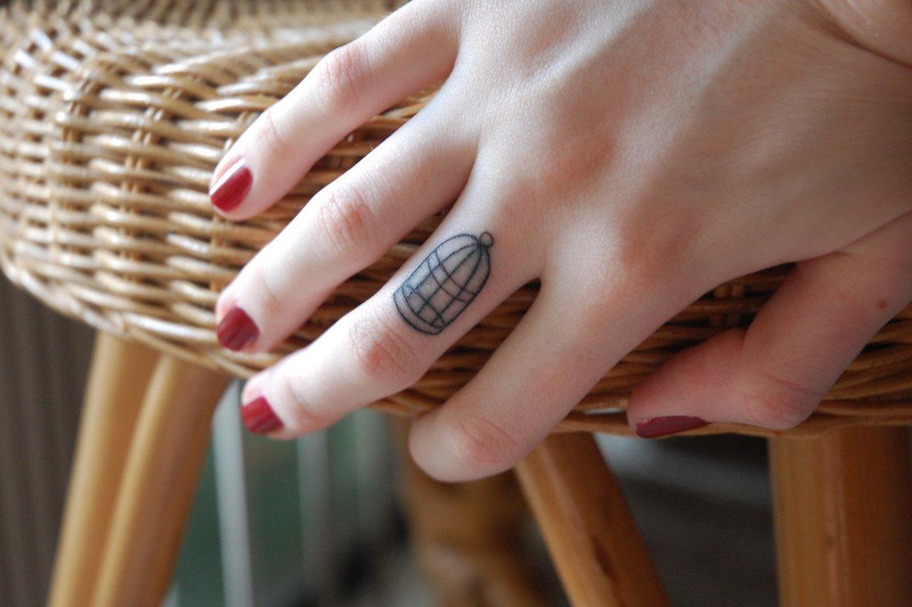 Cage tattoo on the finger for women