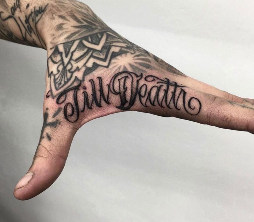 Tattoo with an inscription on the finger for men