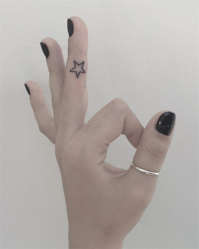 Star tattoo on the finger for women