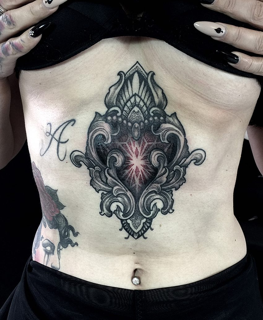 Large baroque tattoo on the abdomen for women