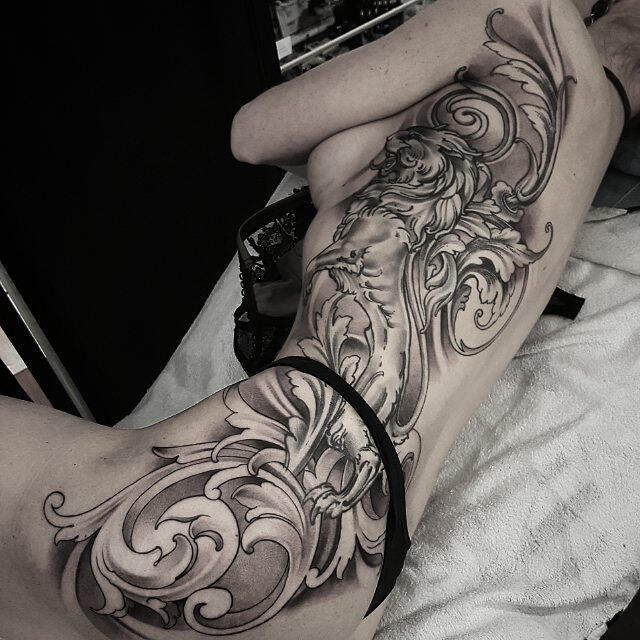 Large baroque tattoo on the side for women