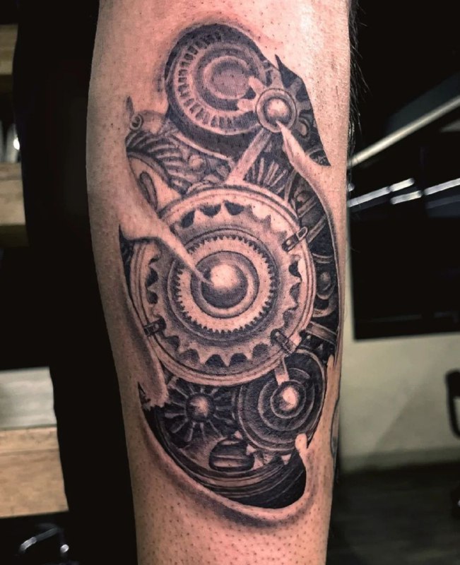 Large biomechanics style tattoo on the forearm for men