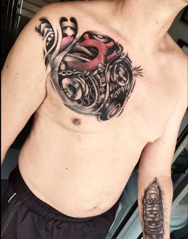 Colored tattoo in the style of biomechanics on the chest for men