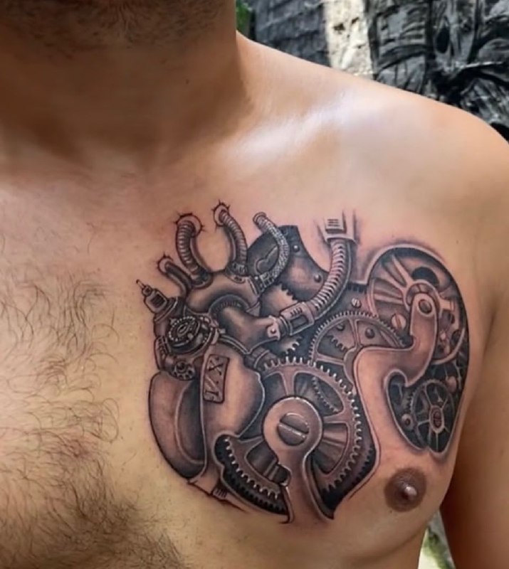 Biomechanics style tattoo on the chest for men