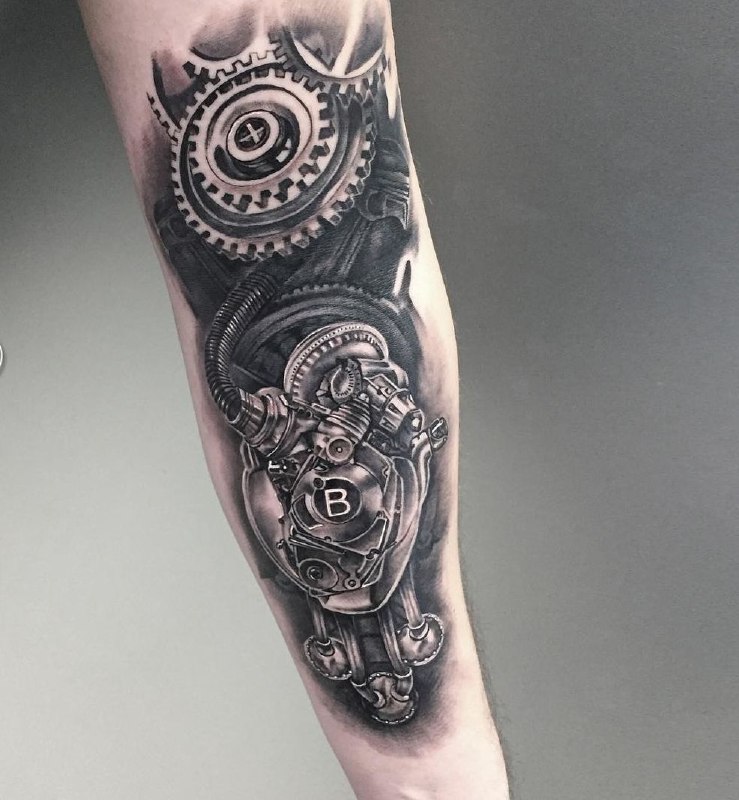 Biomechanics style tattoo on the forearm for men