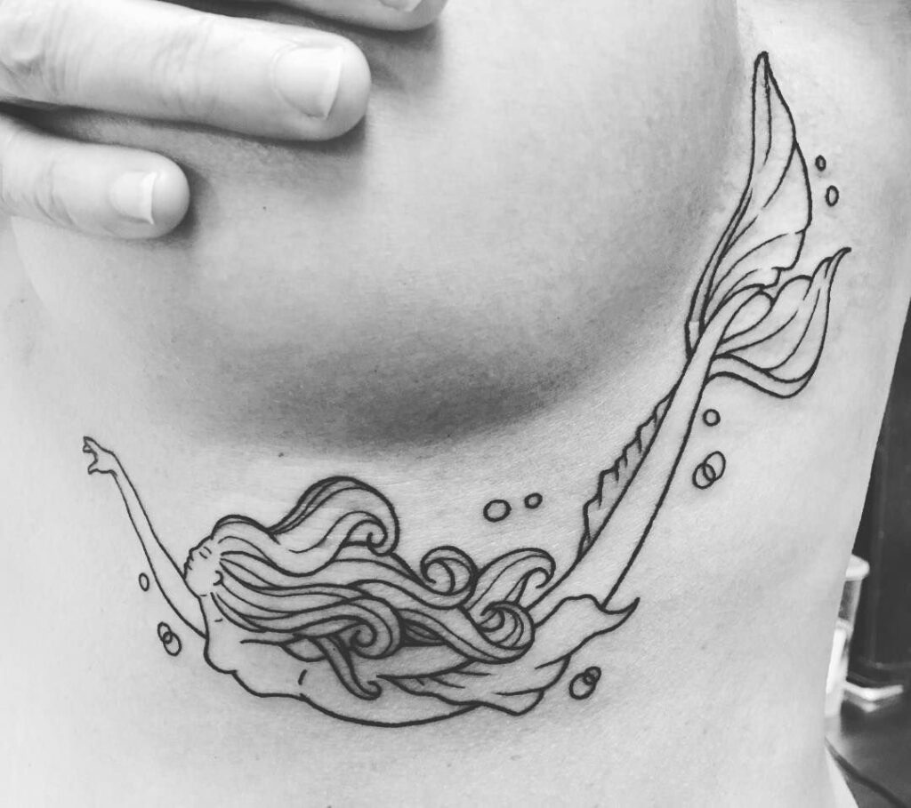 Mermaid tattoo on the chest for women