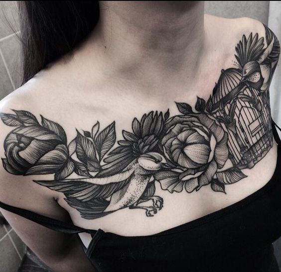 Tattoo of two birds and flowers on the chest for women