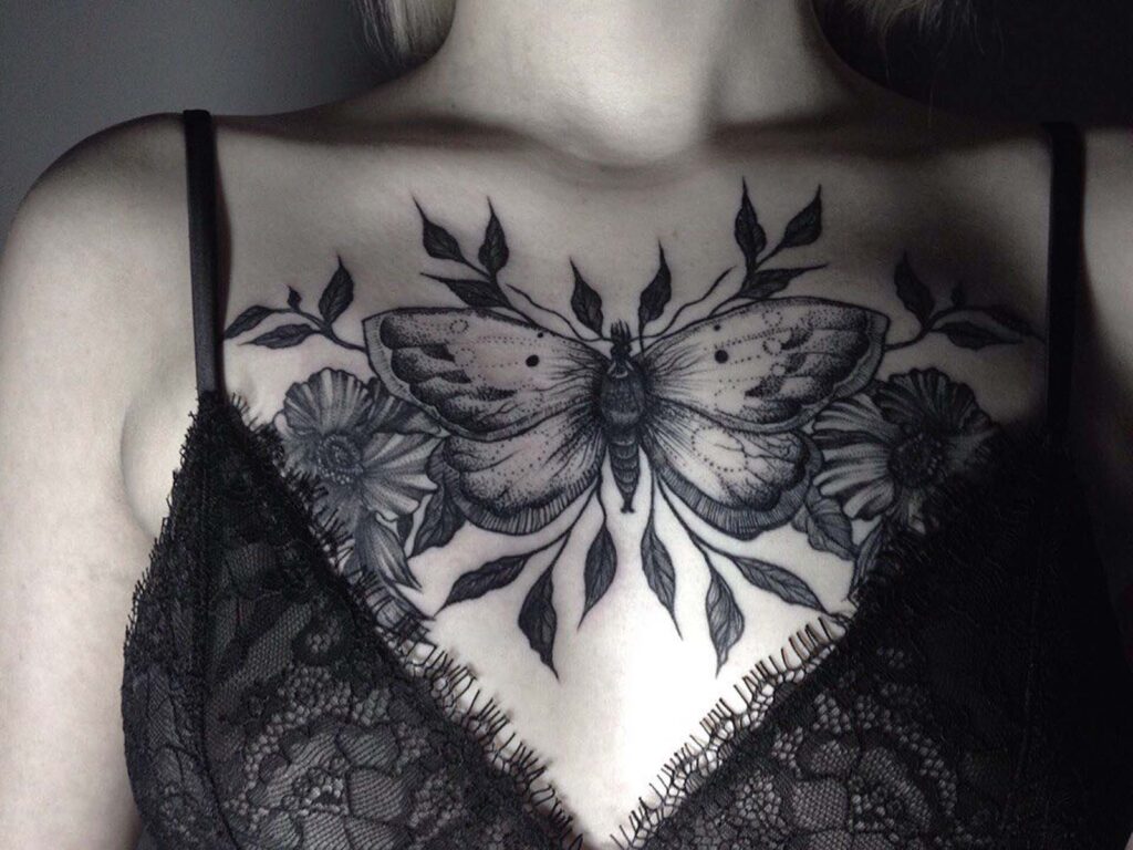 Large butterfly tattoo on the chest for women