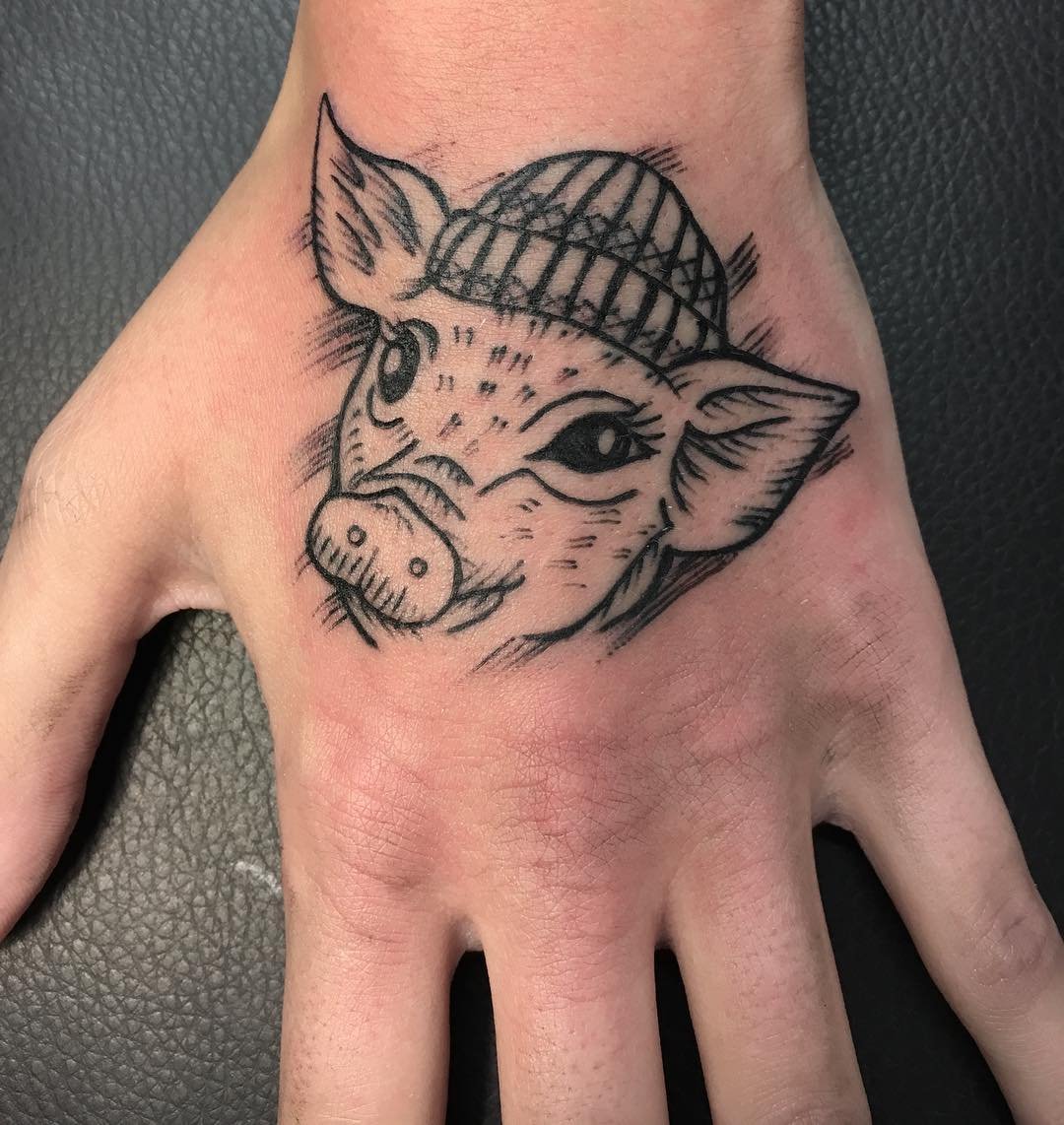 Pig tattoo on the hand for women