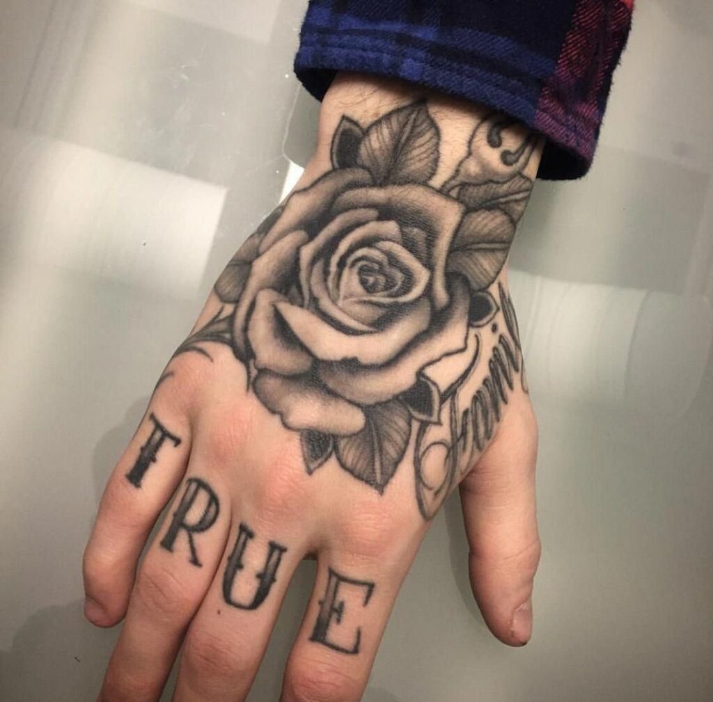 Large rose tattoo on the hand for men