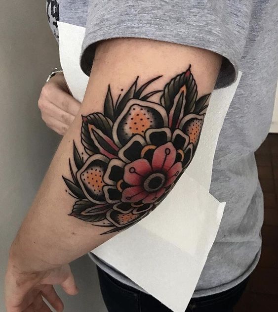 Color tattoo on the elbow for men