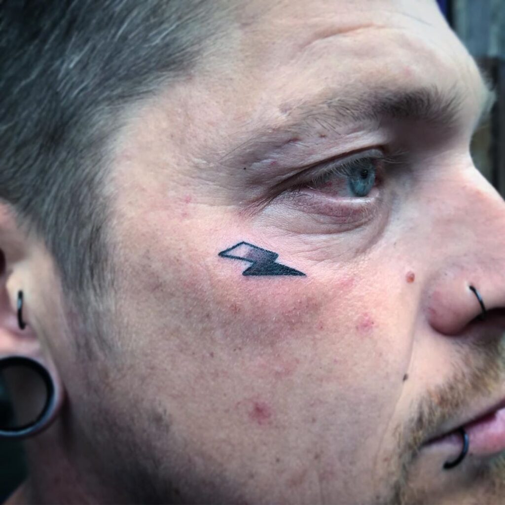 Lightning tattoo on the face for men