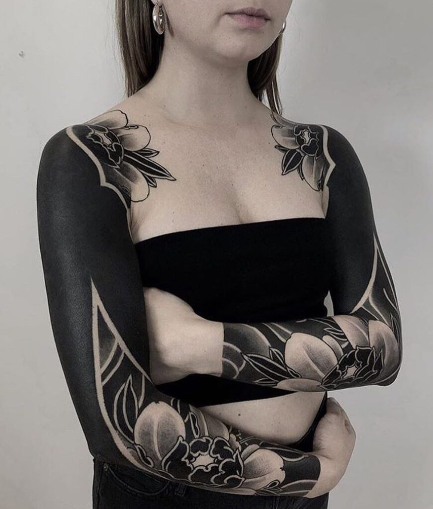 Blackwork tattoo on the arm for women