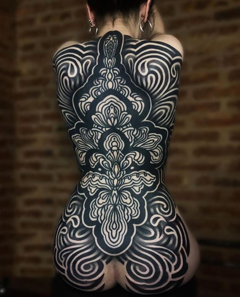 Blackwork tattoo on the back for women