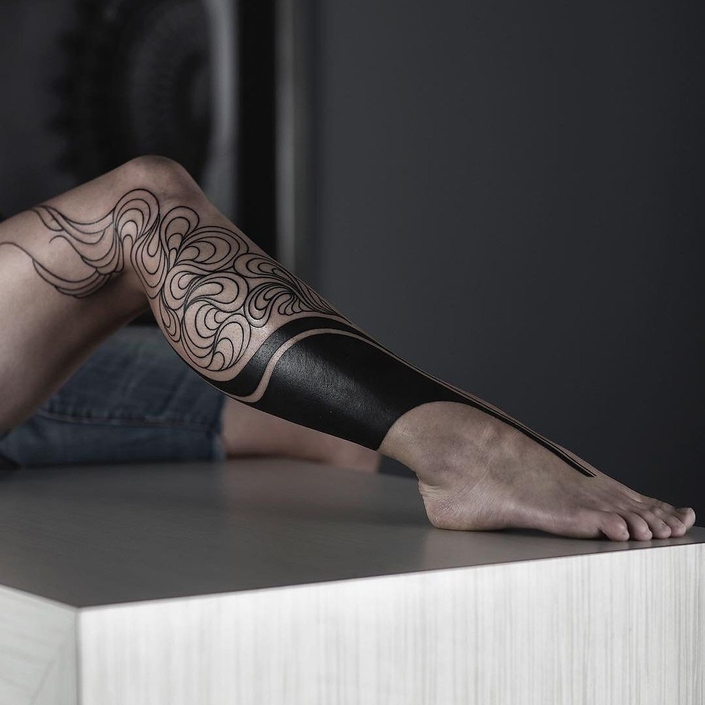 Blackwork tattoo on leg for women