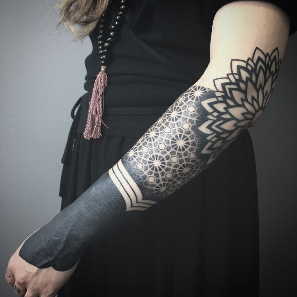 Blackwork tattoo on arm for women