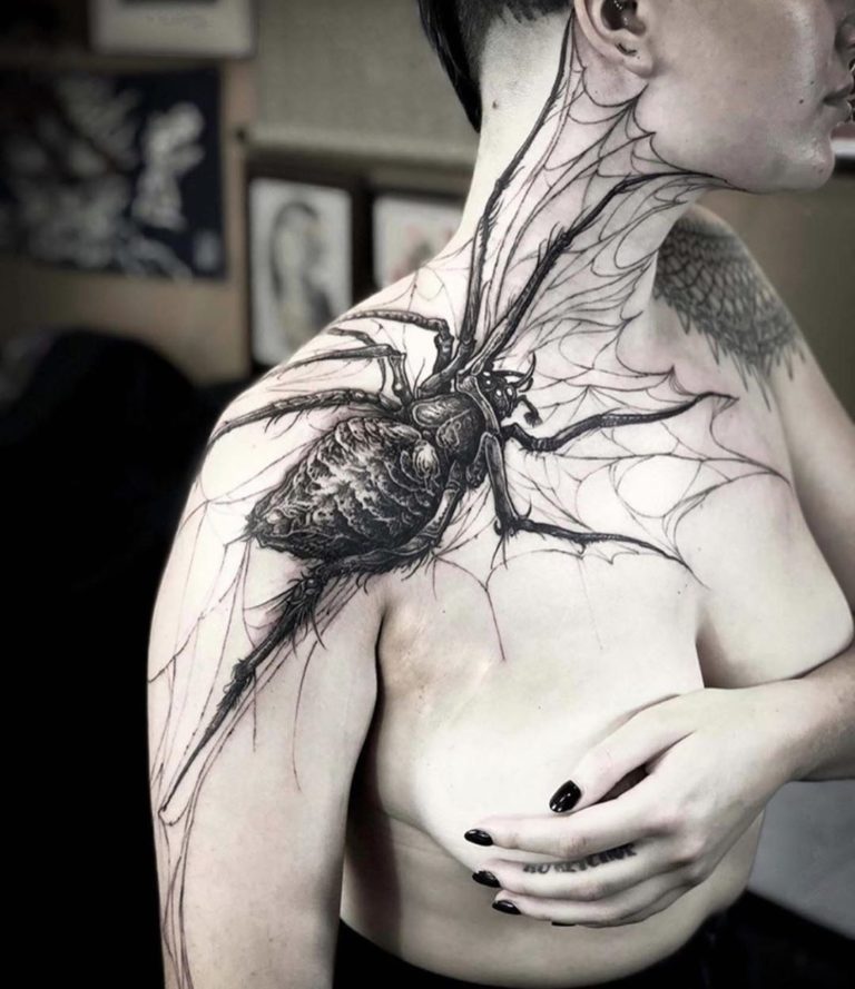 Blackwork spider tattoo on the shoulder for women