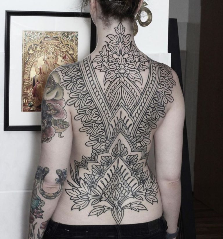 Blackwork tattoo on the back for women