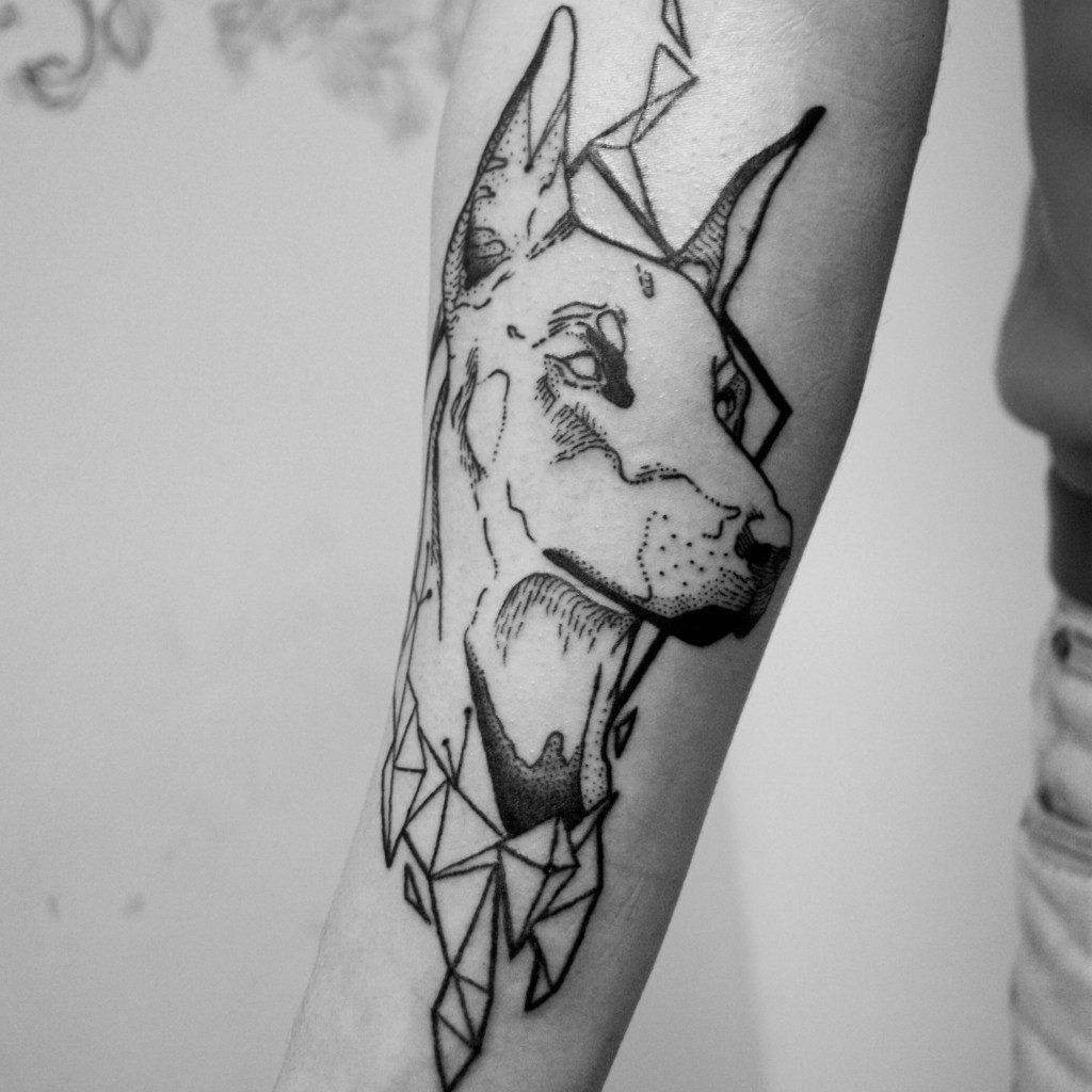 Doberman tattoo in graphic style on the forearm for men