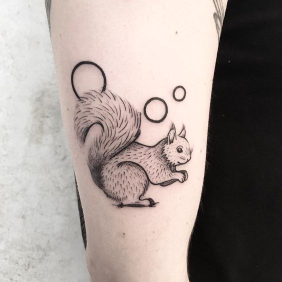 Squirrel tattoo in graphic style on the shoulder for women