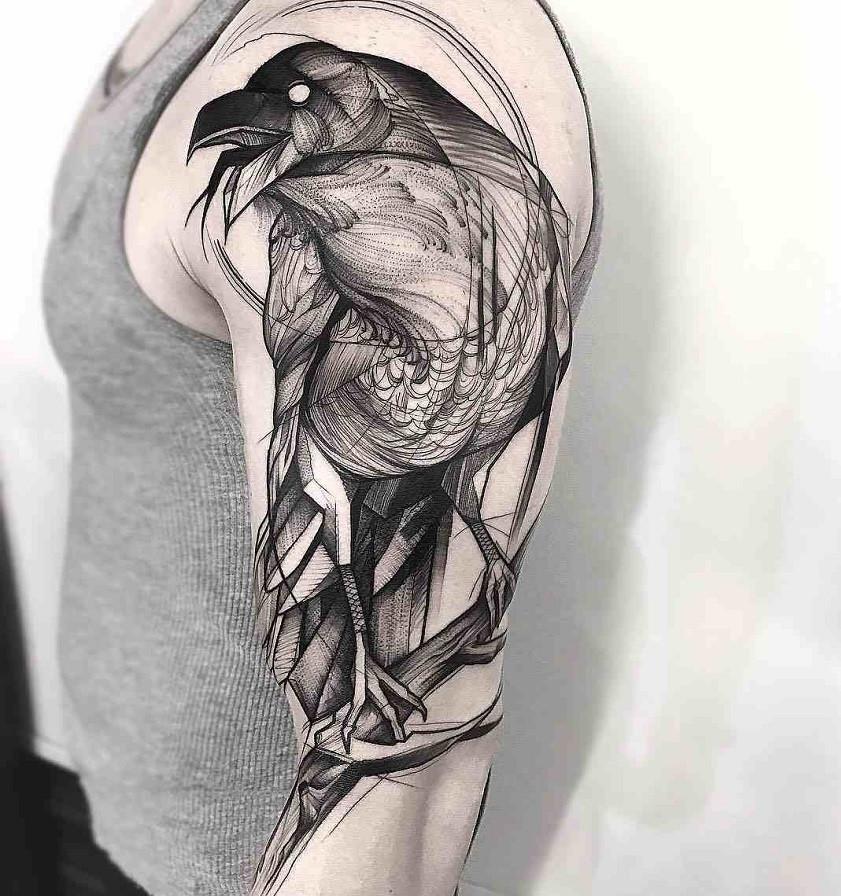 Large graphic-style raven tattoo on the shoulder for men