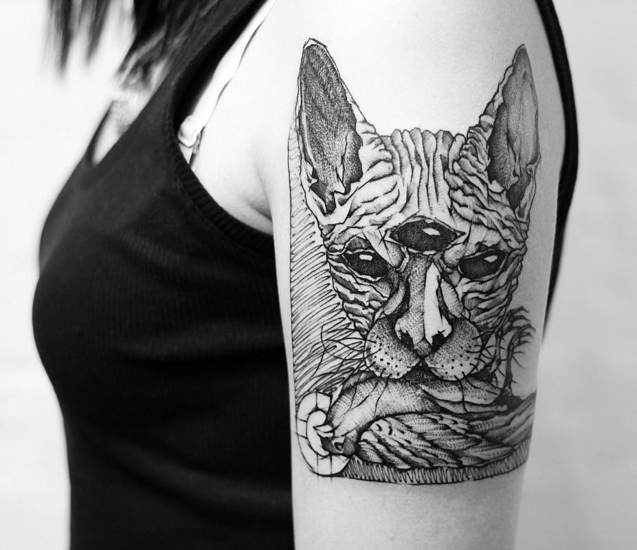 Large cat tattoo on the shoulder for women