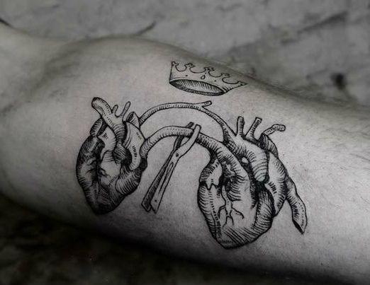 Heart tattoo in graphic style on the biceps for men