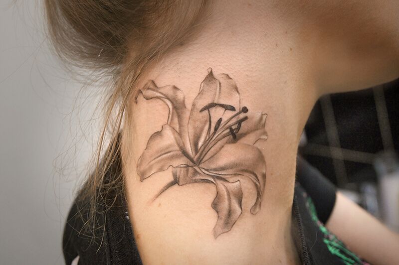 Lily tattoo on the neck for women