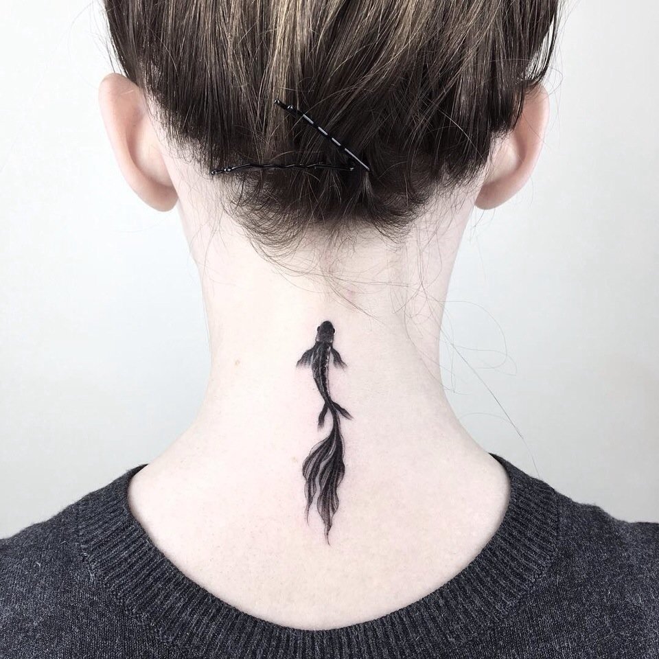 Fish tattoo on the neck for women