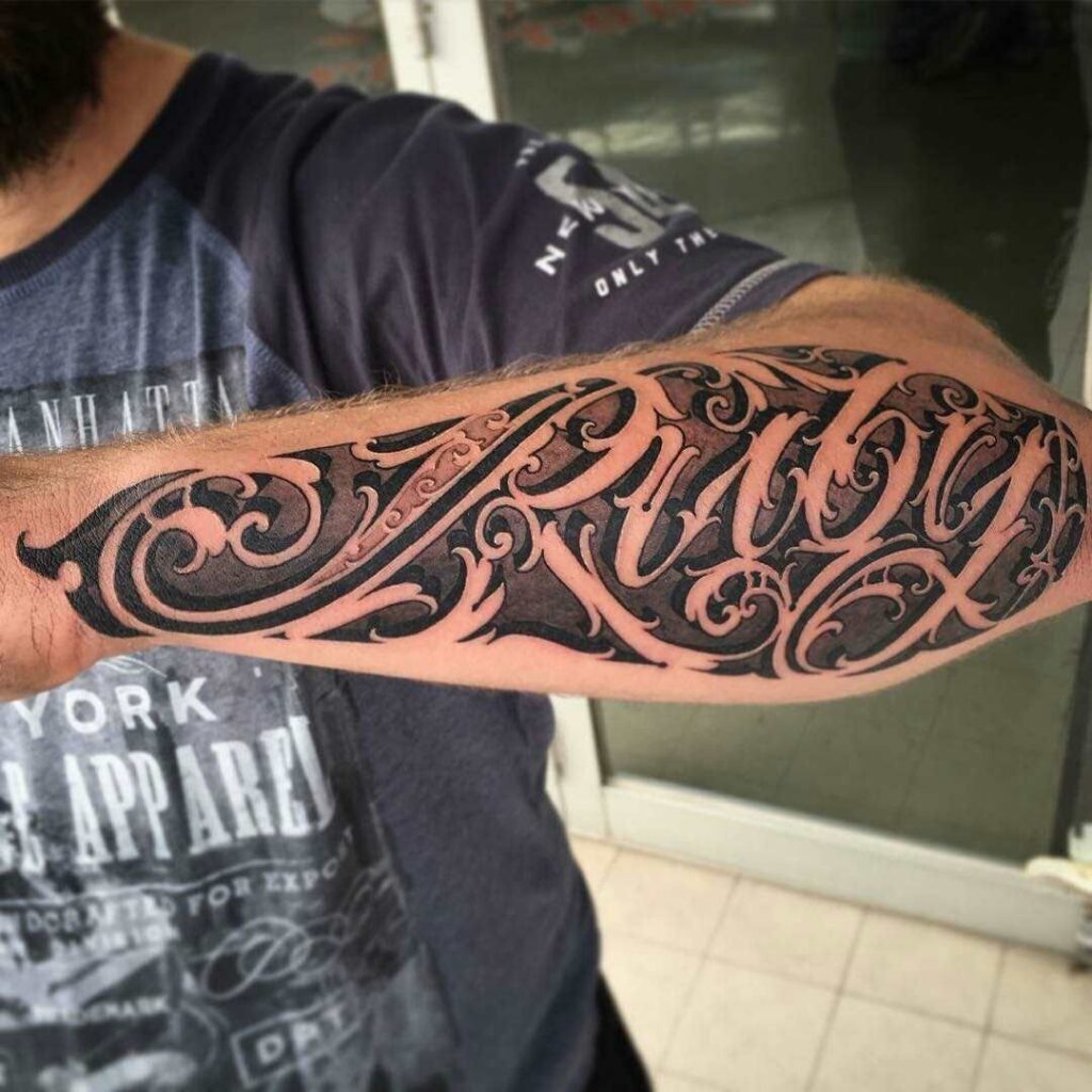 Large tattoo with an inscription on the forearm for men