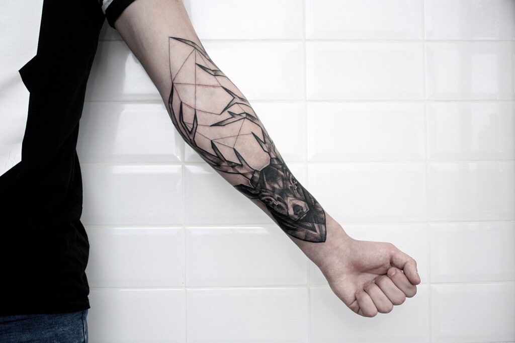 Large deer tattoo on the forearm for men