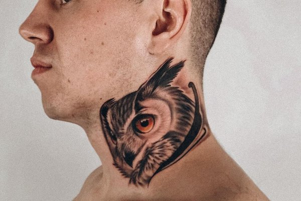 Large owl tattoo on the neck for men