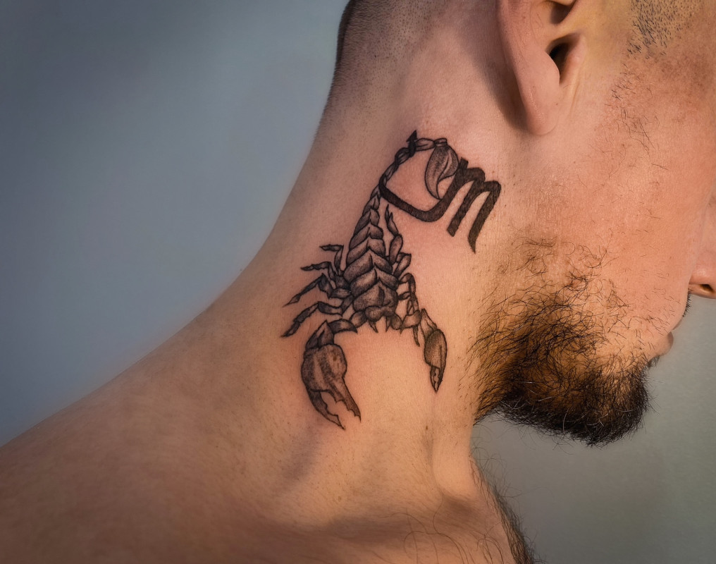 Tattoo of the zodiac sign of a scorpion on the neck for men